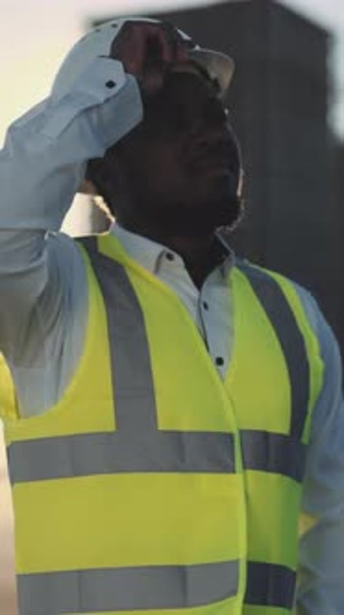 African American Builder Using Mobile App in Construction Site Portrait Shot Professional Foreman or