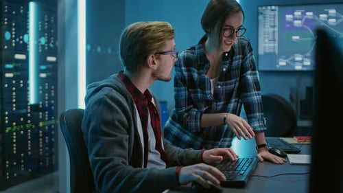 Male and Female Programmers Talking, Solving Problem, Using Computers. Software Development / Code
