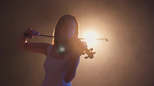 Woman Plays Violin with Professional Lighting in Studio