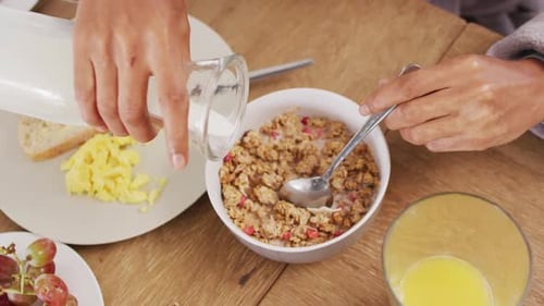 Video of hands of caucasian man preparing cereals for breakfast