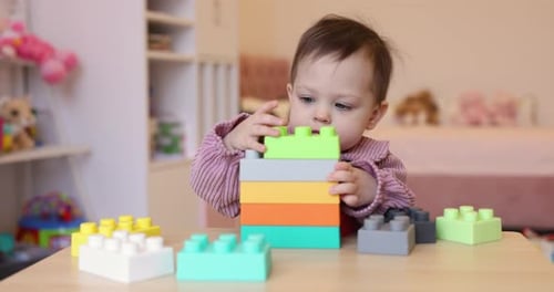 Caucasian Little Child Girl Playing with Construction Blocks