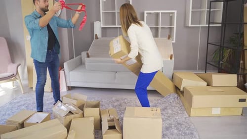 Couple unpacking boxes in new home