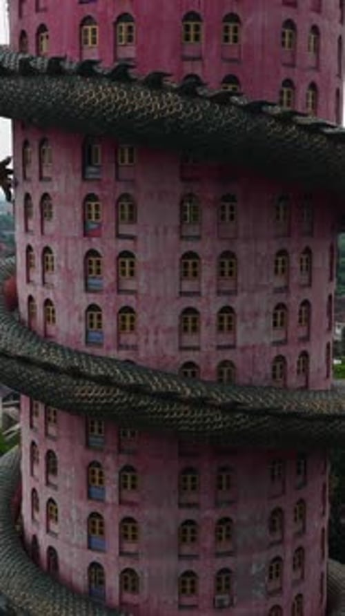 Wat Samphran a Buddhist Temple Exhibits a Unique Pink Cylindrical Building with a Huge Green Dragon