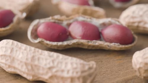 Closeup view of fresh peanuts on wooden table. Macro shot