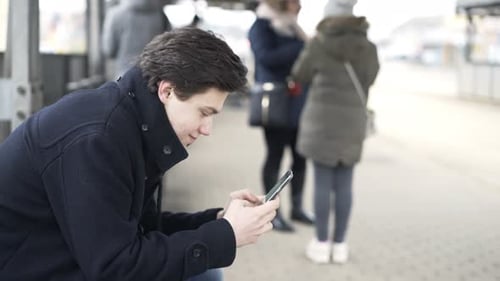 Teenager Surfing Internet, Texting On Smartphone In The City