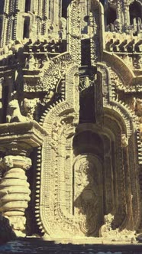 A Stone Building with a Beautiful Statue in Front of It