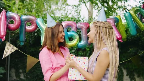 Two Young Women Celebrate Birthday With Gift