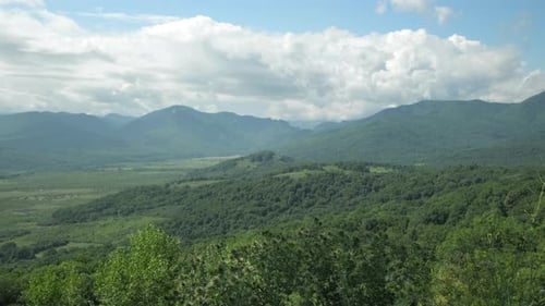 Beautiful Countryside View on Mountains Valley and Sky with Clouds in Summer