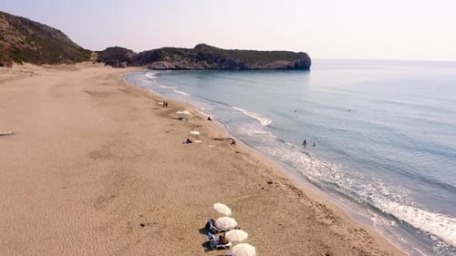 Sandy Beach Near the Ocean and Mountains on the Island