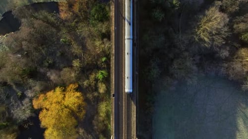 Fast Commuter Train Passing Over a Viaduct Bird's Eye View