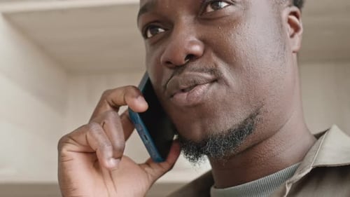 Adult Man Talking on Phone Close-Up Indoors