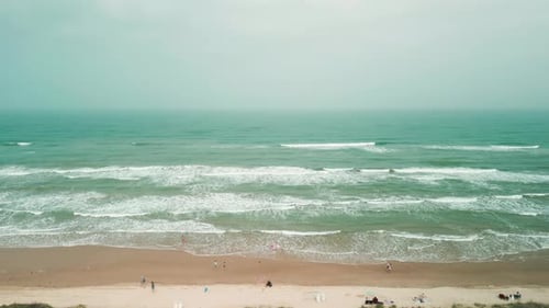 Drone Wide Shot of Sand Beach on a Summer Day While Turquiose Sea Waves Breaking on Sandy Coastline