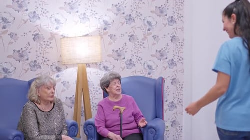 Caregiver with Senior Women in Cheerful Room