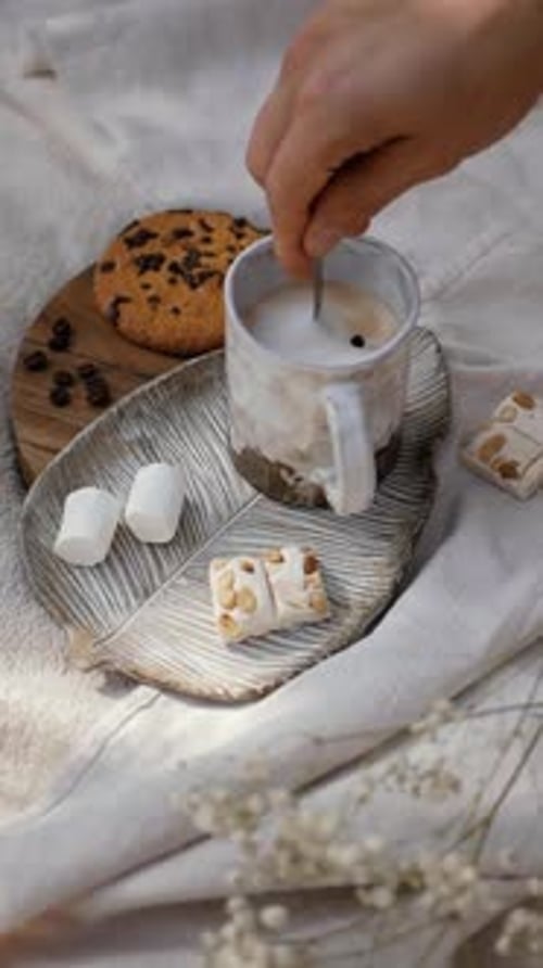 Stirring Coffee with Cookie, Marshmallows and Nougat