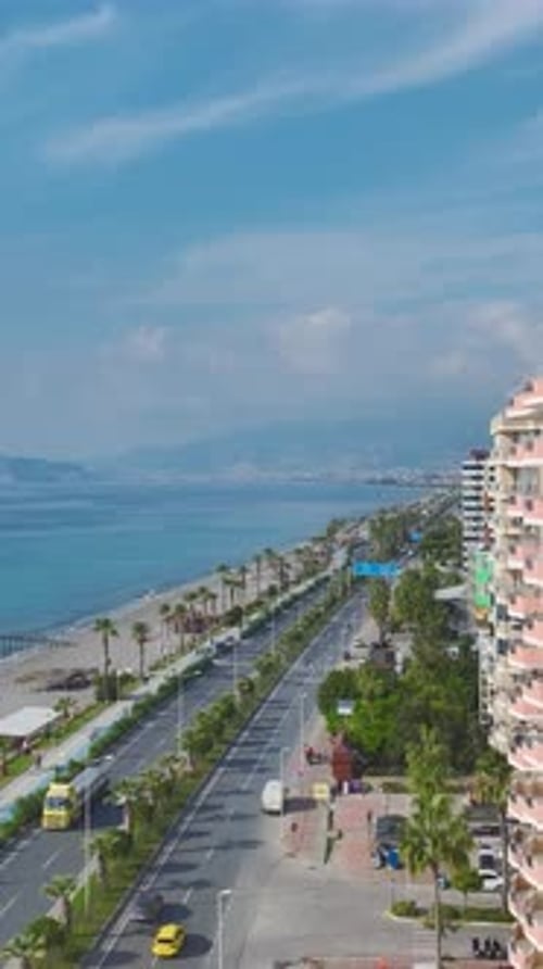 Vertical Video Aerial View of Balconies on a Stylish Facade Facing the Blue Mediterranean Waters