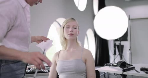 Makeup Artist Applying Makeup to Beautiful Woman