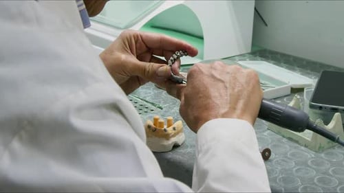 Dentist Using Drill on Artificial Teeth