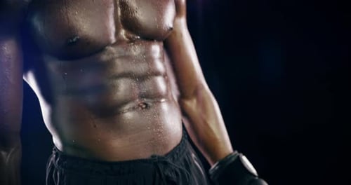 4k video footage of an athletic young man against a black background