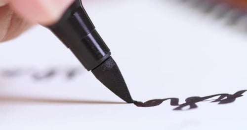 Artistic writing process close-up of calligraphy creative studio environment