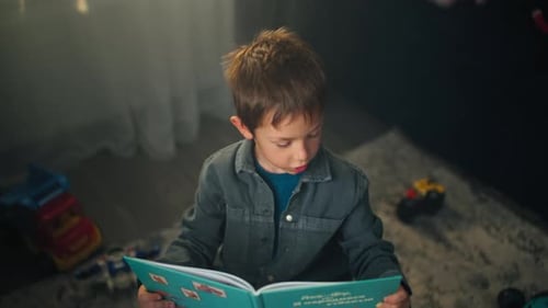 Boy Reading a Book on the Floor