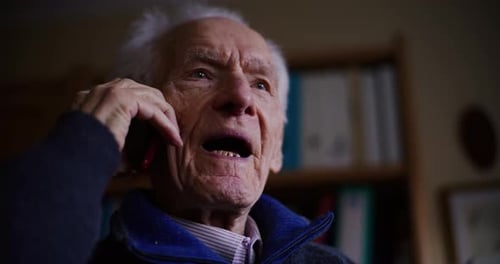 Senior Man Talking on Smartphone Indoors