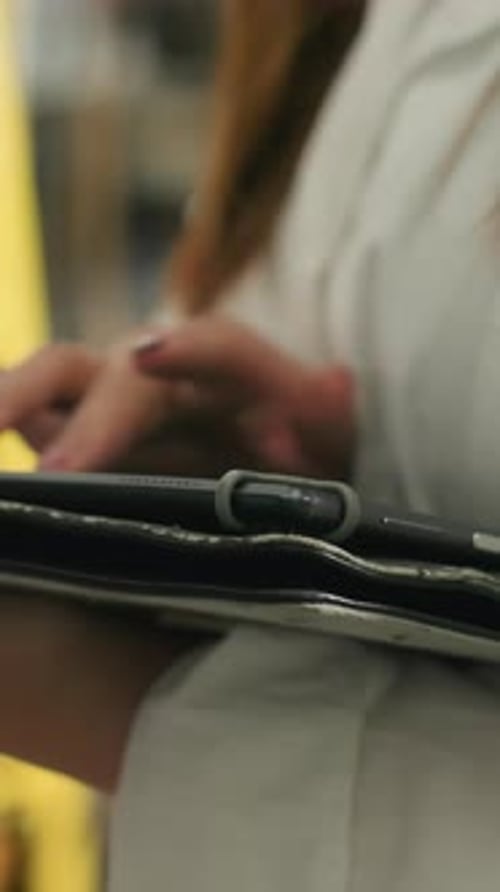CloseUp of Lady Using Tablet in Mechanical Workshop