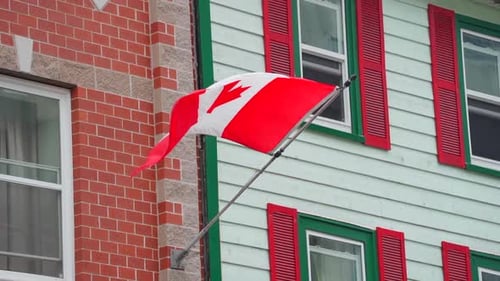 Canadian Flag Waving on Building Facade