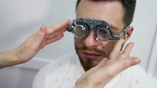 Man Getting Eye Exam with Phoropter in Office