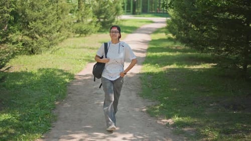 Individual Walking Cheerful Path Person Progressing Along Sunny Trail Smiling Gentle Sunlight