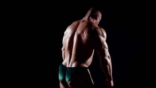 Muscular Bodybuilder Flexing Back Muscles Close Up