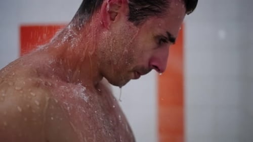Handsome Man Taking Refreshing Shower in Modern Bathroom