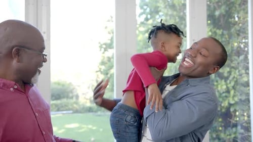 Three Family Members Laughing Together Indoors