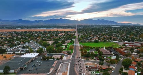 Transport goes by the long straight highway crossing the green neighborhoods.