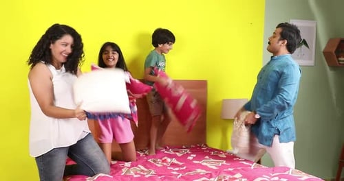 Happy Family Pillow Fight on the Bed