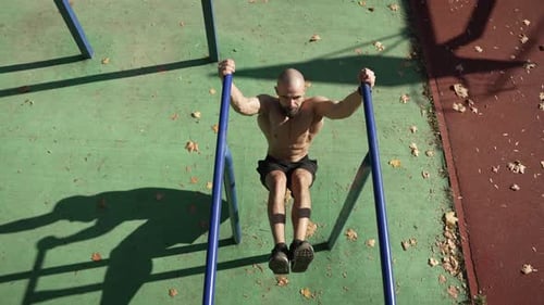 A Man Does Sports on a Horizontal Bar