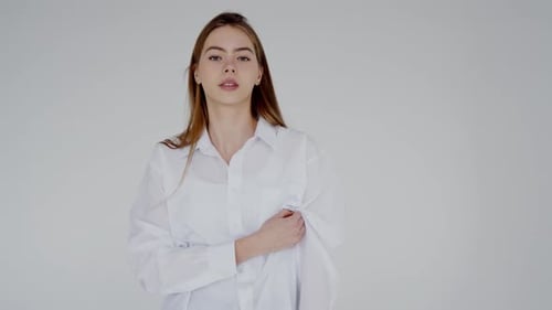 Woman with Brown Hair Poses in Oversized Shirt