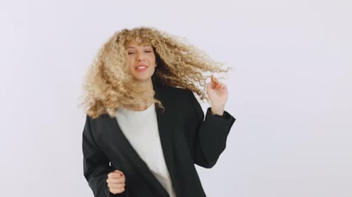 Stylish Woman with Curly Hair Dancing Joyfully