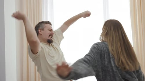 Man and Woman Dancing Together in a Bright Room