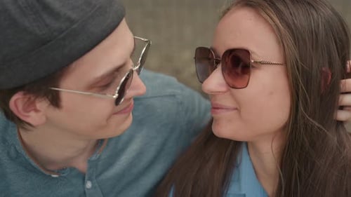 Loving Couple Embracing and Kissing in City