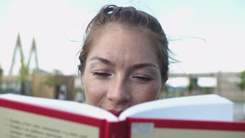 Woman Reads a Book in the Park