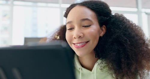 Smiling Teen Engaged with Tablet Technology Indoors