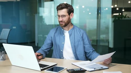 Mature businessman in shirt doing paperwork man working with documents contracts and bills sitting