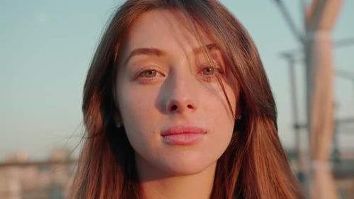 close-up face portrait of a young beautiful emotional woman in depression looking at the camera