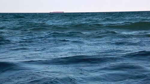 A ship on the horizon of an ocean