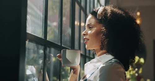 Woman Smiling and Enjoying Coffee by the Window