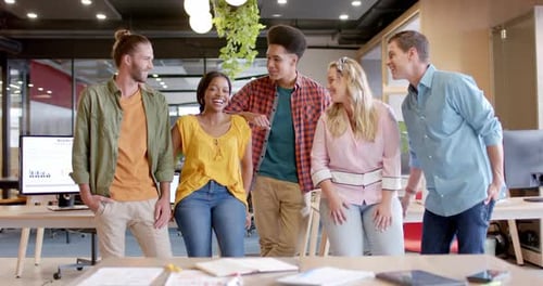 Portrait of happy diverse business people in office in slow motion
