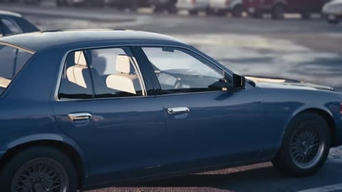 Blue Vintage Car Parked During the Golden Hour in an Urban Area