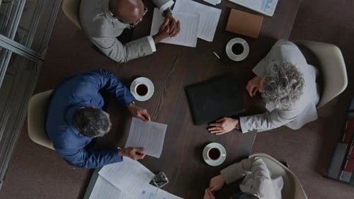 Four Business People Meeting at a Conference Table