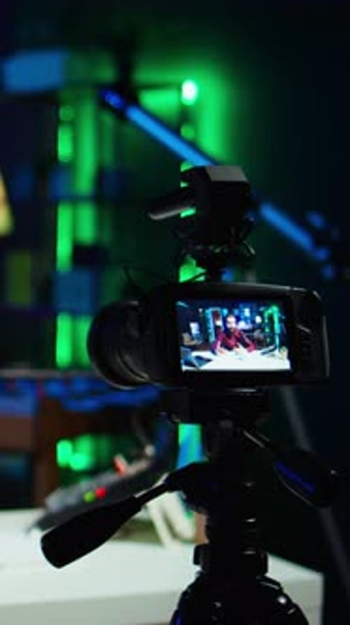 Vertical Video Focus on Professional Camera Used By Man Hosting Online Show
