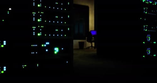 Bright Server Lights Illuminate a Dark Room in a Data Center at Night